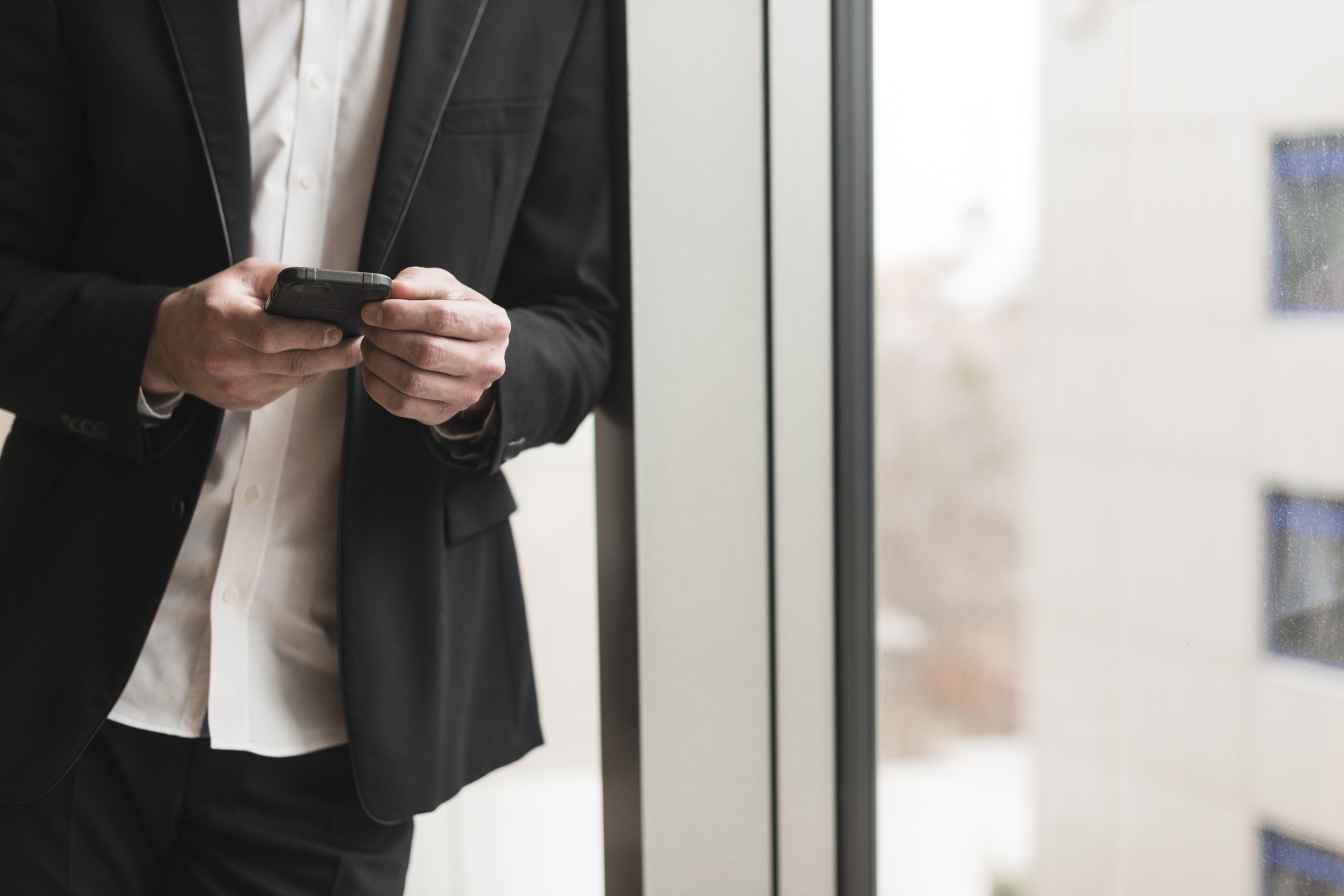 man-suit-with-smartphone_23-2147768638
